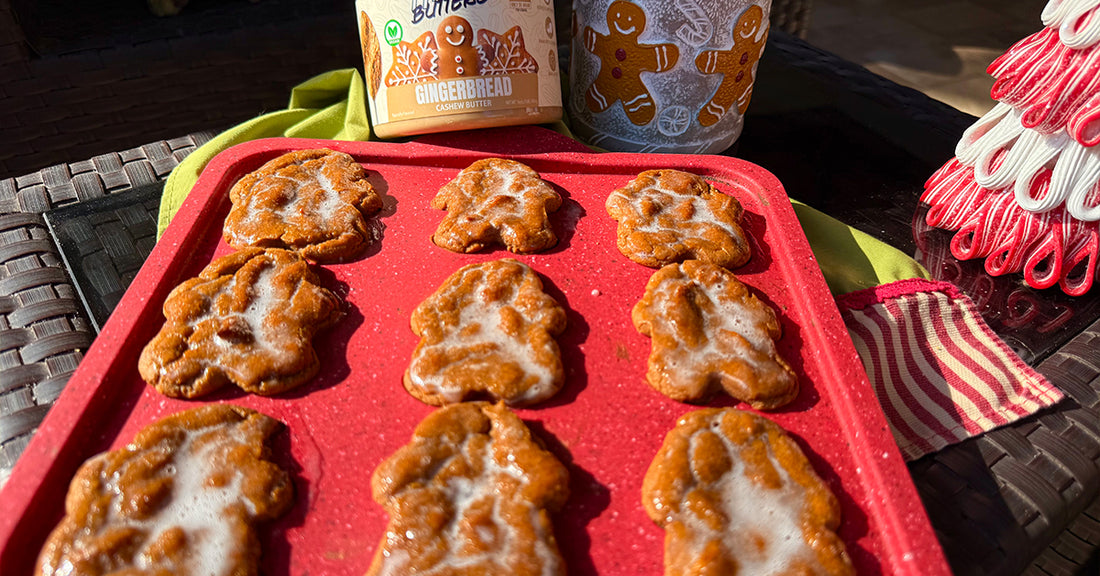 Soft healthy gluten-free gingerbread donuts shaped like gingerbread men with cashew butter, maple glaze
